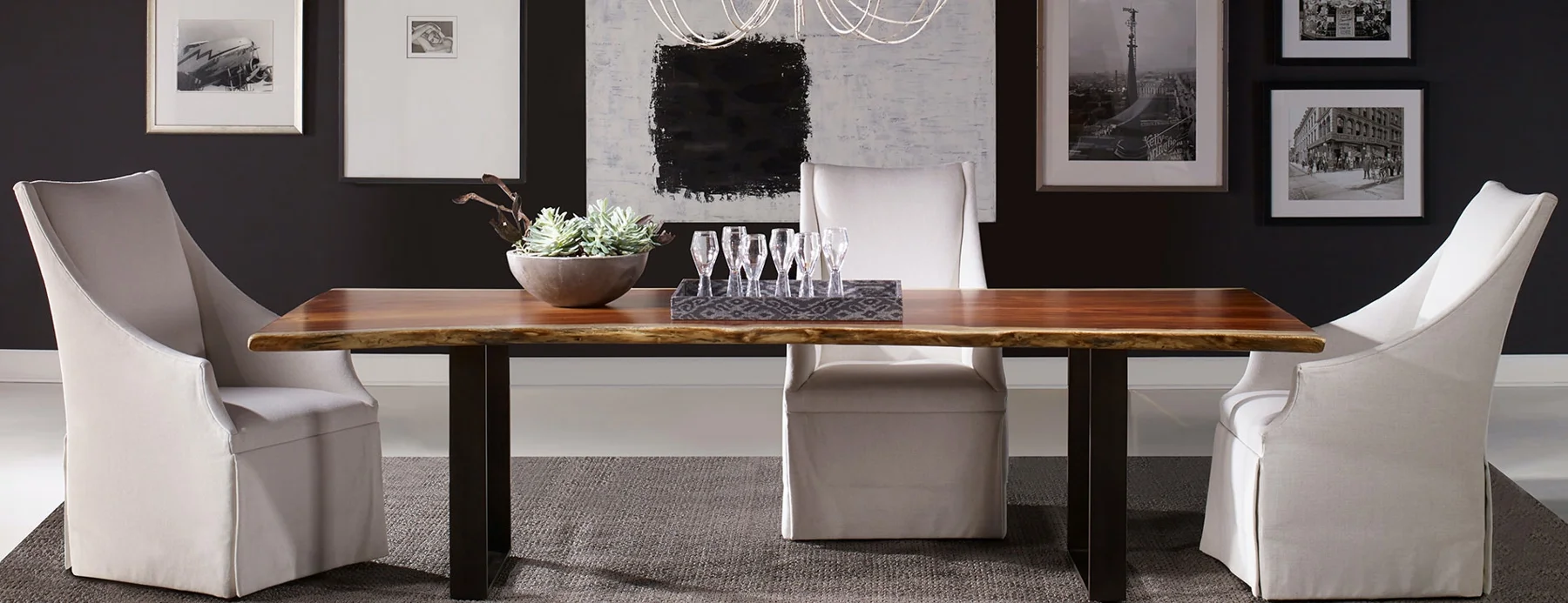 Wood dining table surrounded by upholstered chairs
